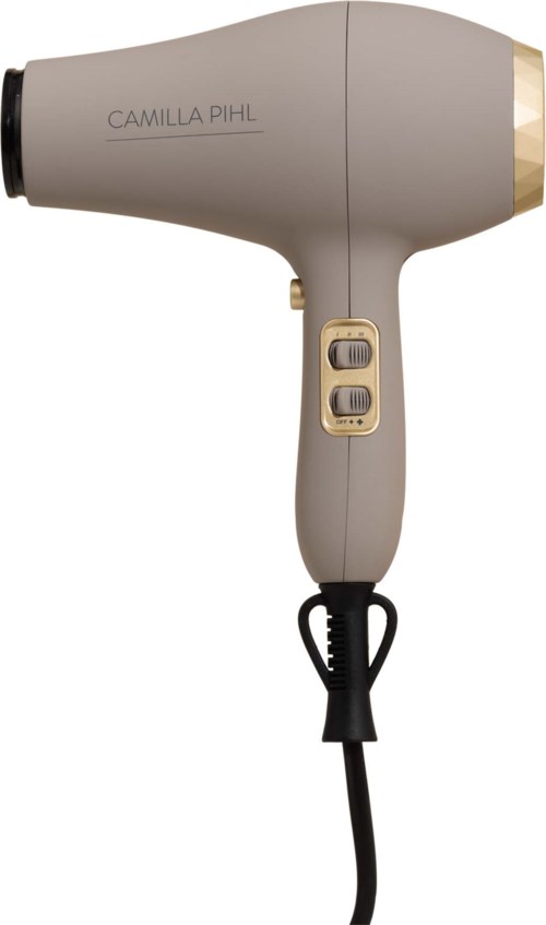 A beige Camilla Pihl hairdryer with switches and a black cord.
