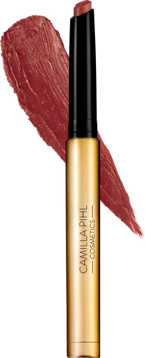 Lipstick in a gold tube with a black cap, swatched on a textured red background.