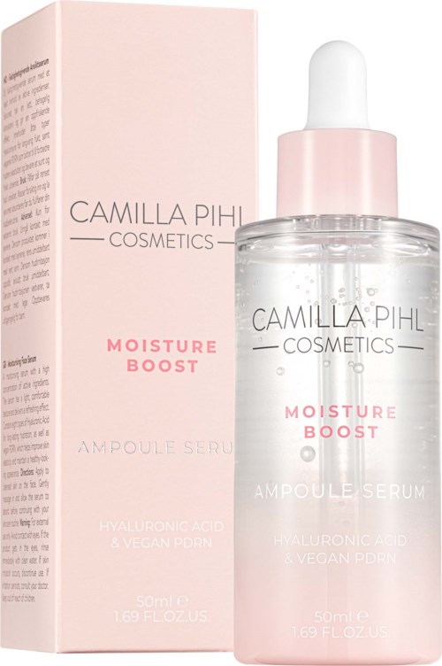 A skincare bottle and box, labeled Camilla Pihl Cosmetics Moisture Boost, with a dropper and pink design.