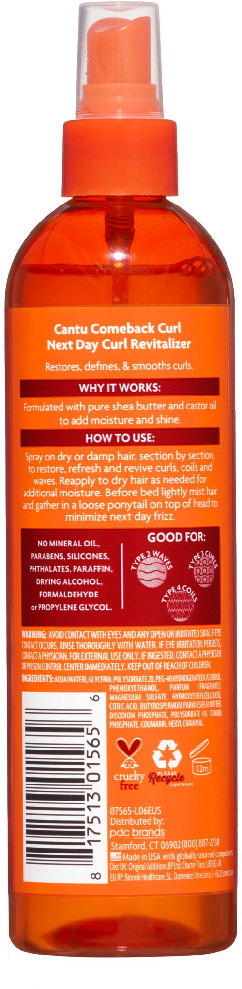 Orange sprayflaska med etikett om hårlockar och vård. Innehåller instruktioner och ingredienser för hårvård.