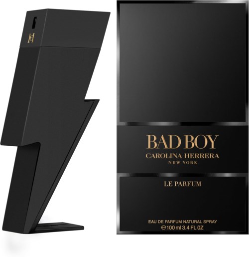 A perfume bottle shaped like a lightning bolt stands next to a black box with gold text for Bad Boy fragrance.