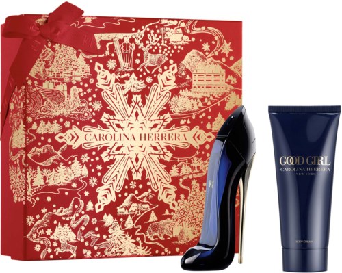 En röd presentförpackning med guldmönster, en svart och blå högklackad sko, och en blå tub med lotion märkt 'God Girl' och 'Carolina Herrera.'