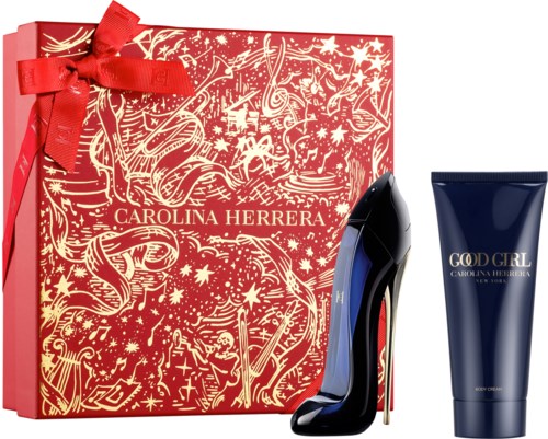 En rød gaveæske med bånd, en sort højhælet sko og en mørkeblå tube, alle fra Carolina Herrera.
