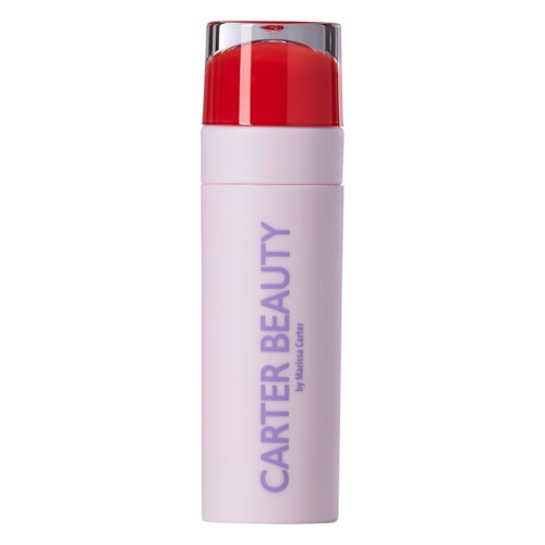 En vit flaska med lila text och röd kork, märkt 'CARTER BEAUTY'.
