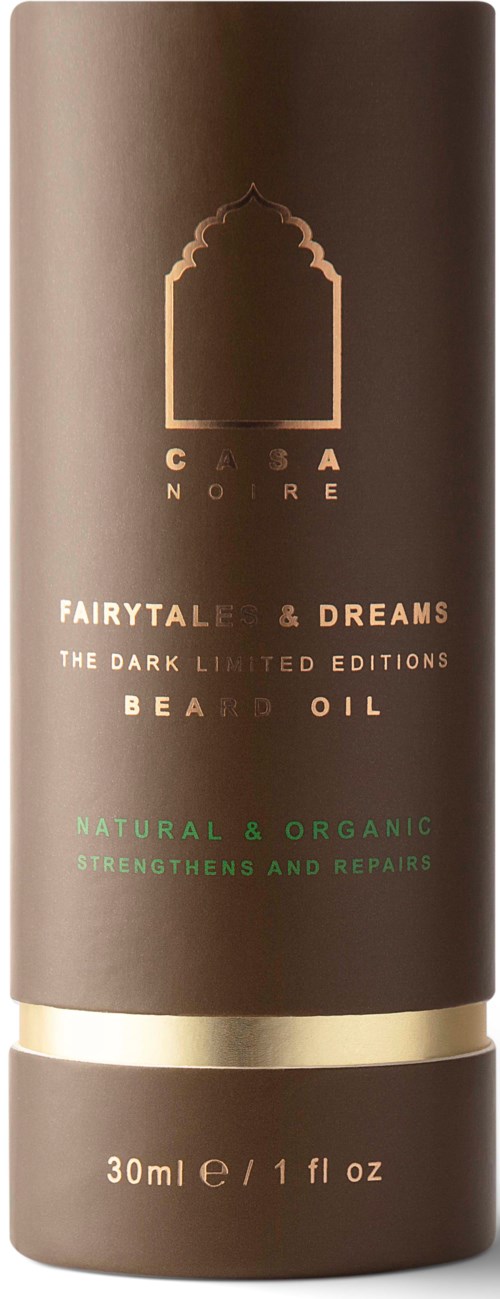 En brun flaska med guldig och grön text, som visar en skäggolja produkt kallad 'FAIRYTALE & DREAMS'.