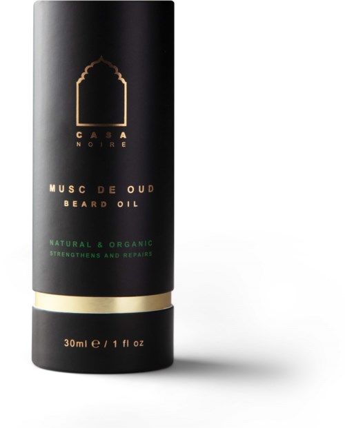 En svart tub med guld- och gröna accentueringar, märkt 'Musc de Oud Beard Oil' från Casa Noire, 30 ml.