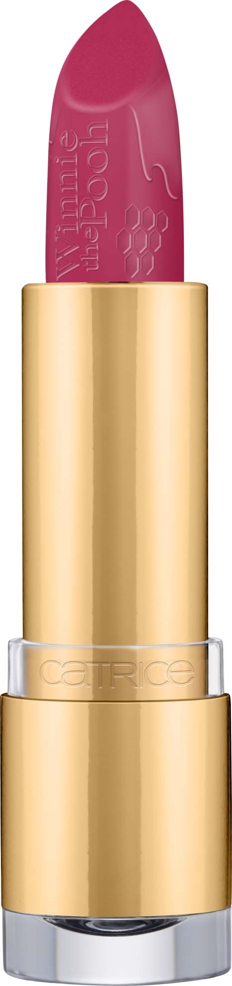 A pink lipstick in a gold case against a black background.