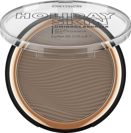 Kompakten innehåller en skimrande bronzer märkt 'Holiday Skin' med en texturerad, brun puder inuti. Locket är genomskinligt med text.