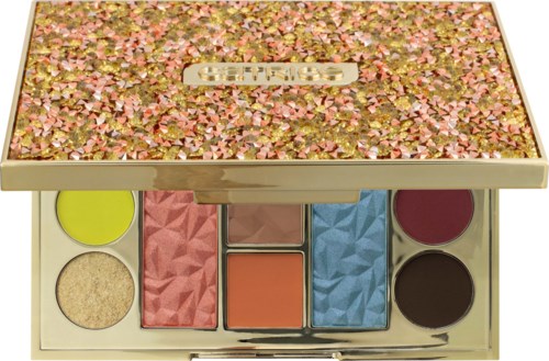 A colorful makeup palette with six different shades, some in solid pans, others as powders, inside a decorated case.