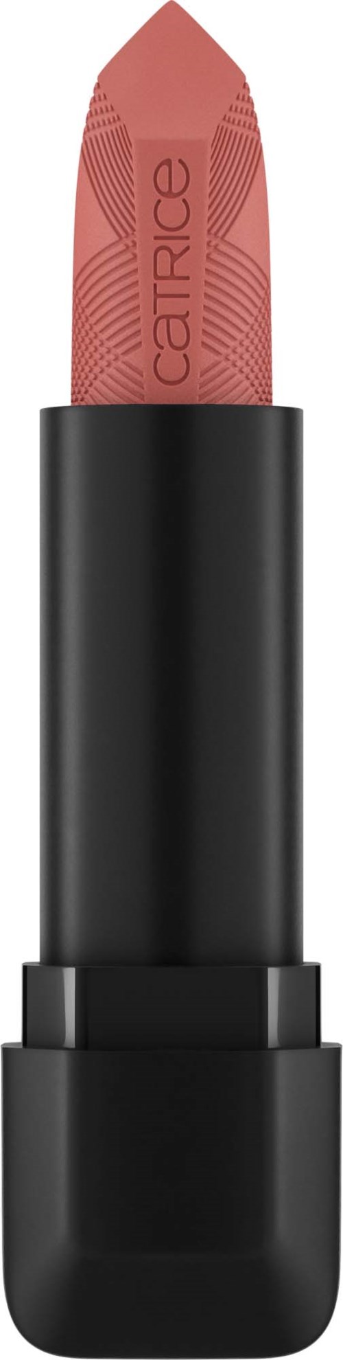 A pink lipstick with a black case shows on a black background.