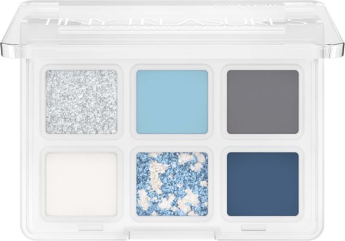 Six eyeshadow shades in a small clear palette, including silver, light blue, dark gray, white, blue glitter, and navy.