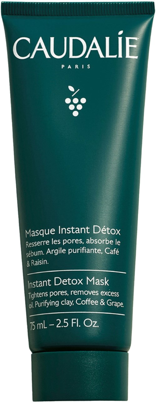 En teal tube av Caudalie Instant Detox Mask med text om porförstärkning och ingredienser som lera, kaffe och druva.