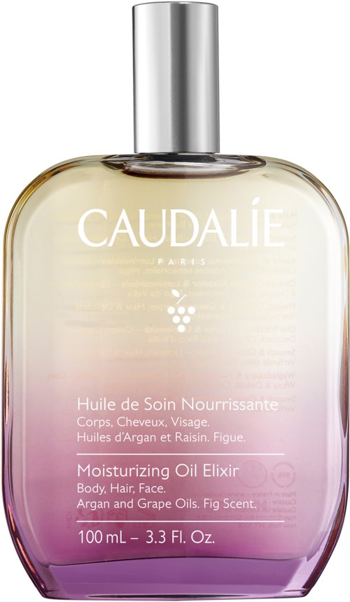 En stor, elegant flaska med Caudalie återfuktande olj-Elixir med en silverkork, ljus lila gradient längst ner.