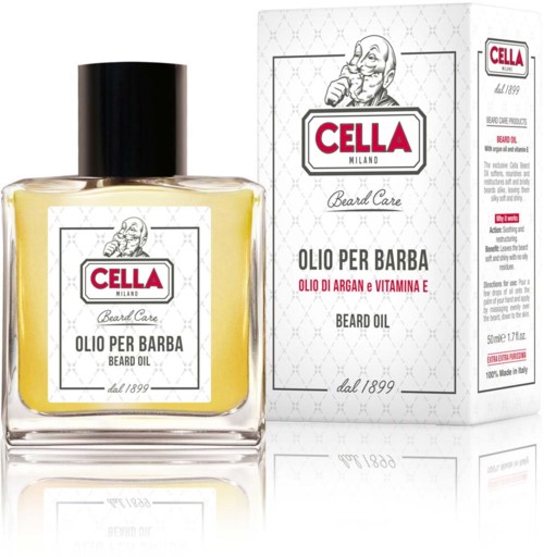 Butelka oleju do brody z etykietą i pudełkiem za nią, obie z logo 'Cella Milano'.
