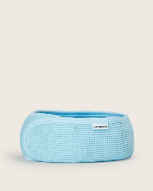 A light blue medical or sports band with a small label, placed on a plain background.