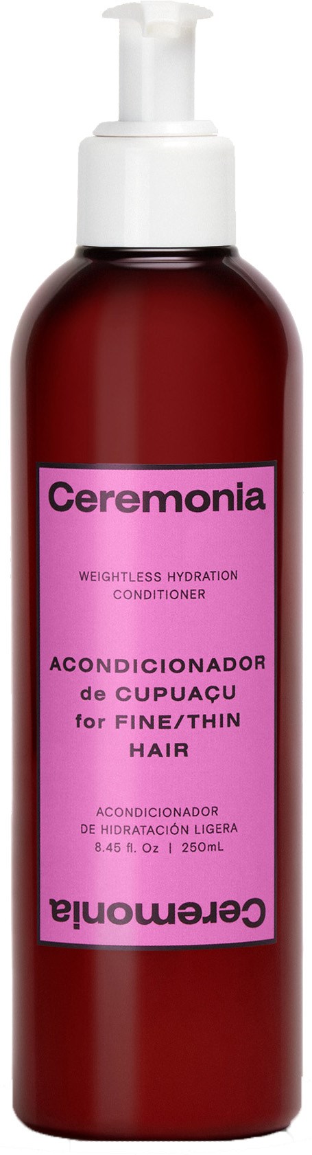 En röd flaska med pump märkt Ceremonia, balsam för fint eller tunt hår, 250 ml.