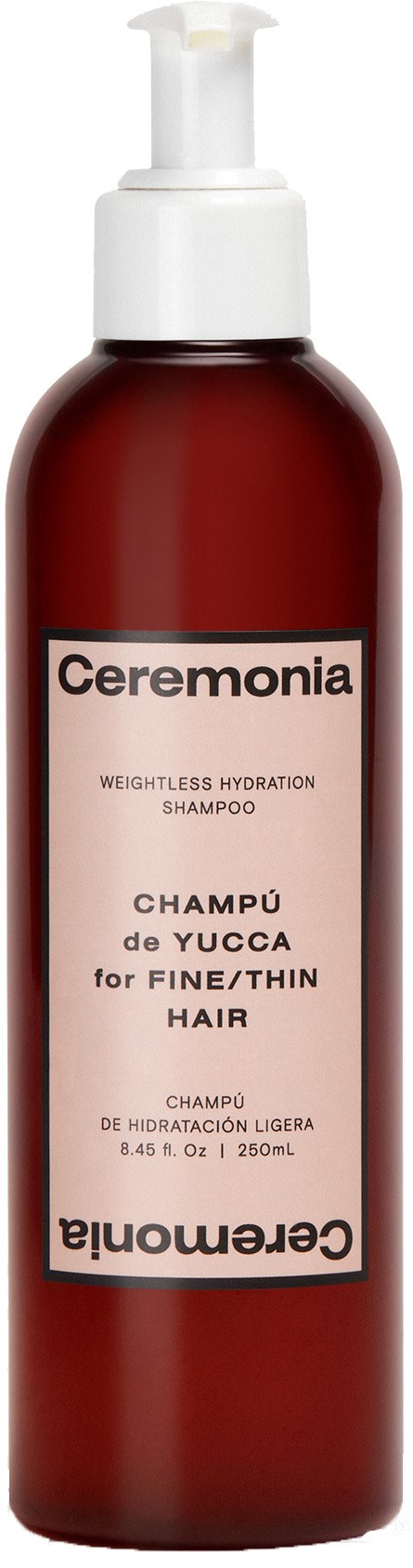 En röd flaska med vit pump innehåller Ceremonia Yucca-schampo för tunt hår, märkt på spanska och engelska.