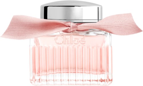 A pink perfume bottle with a silver cap and a pink ribbon tied around it.