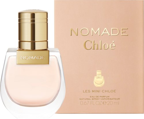 A perfume bottle with a gold cap and a pink box labeled 'Nomade Chloé' and 'Les Mini Chloé' in elegant letters.