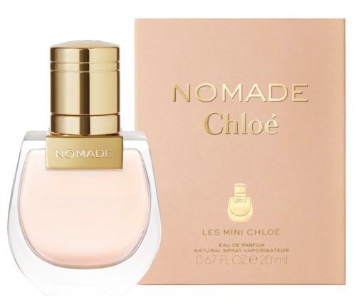 A perfume bottle with a gold cap next to a pink box with gold text for Chloé Nomade fragrance.