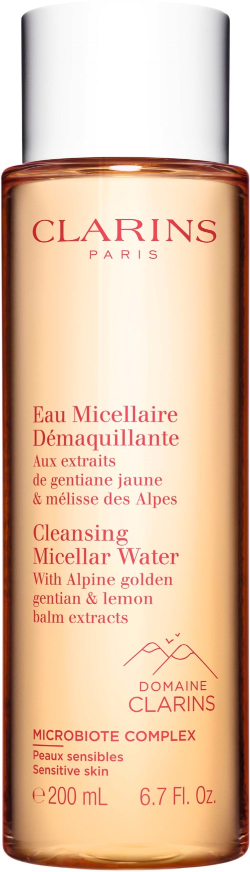 A tall bottle of Clarins cleansing micellar water with yellow and lemon extracts, labeled for sensitive skin care.