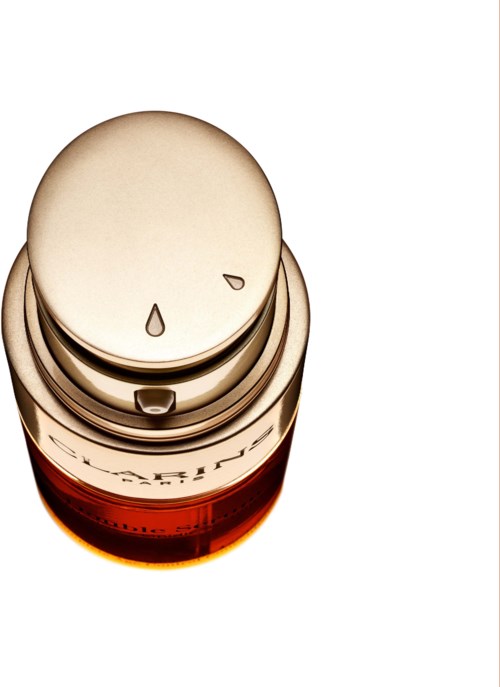 A pill bottle with a white cap and orange bottle base, seen from above on a white background.