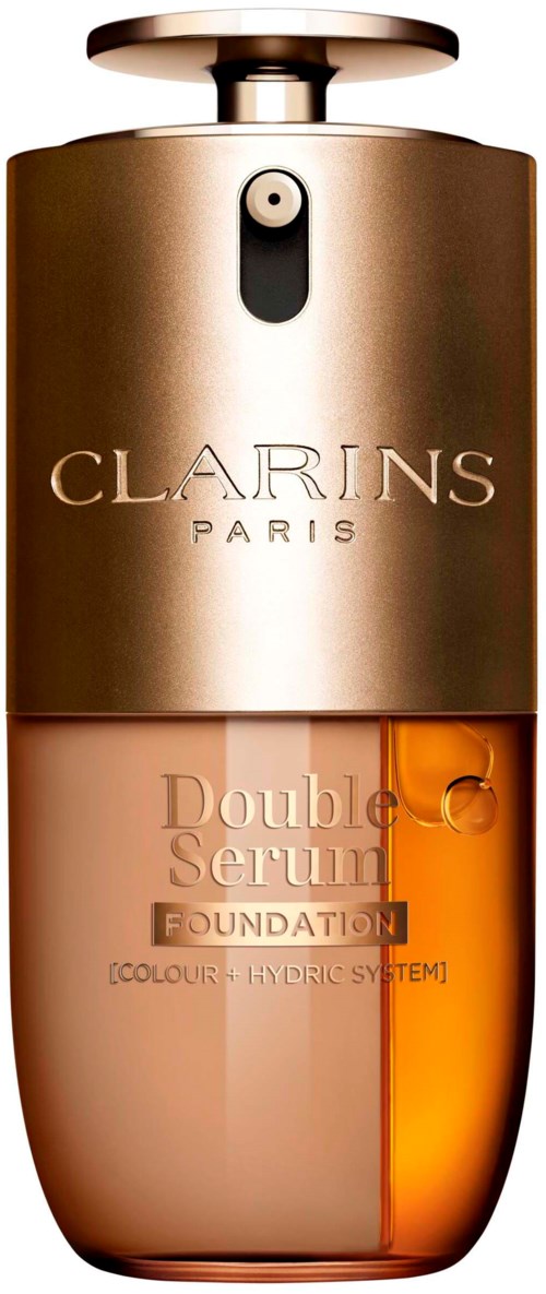 En Clarins-förpackning med gult lock, mörk och ljus beige kropp, och orange serum inuti.