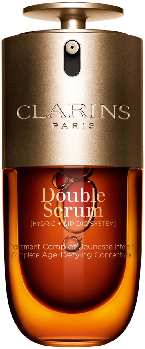 The bottle is orange with a silver cap, labeled Clarins Paris Double Serum, a skincare product for anti-aging.