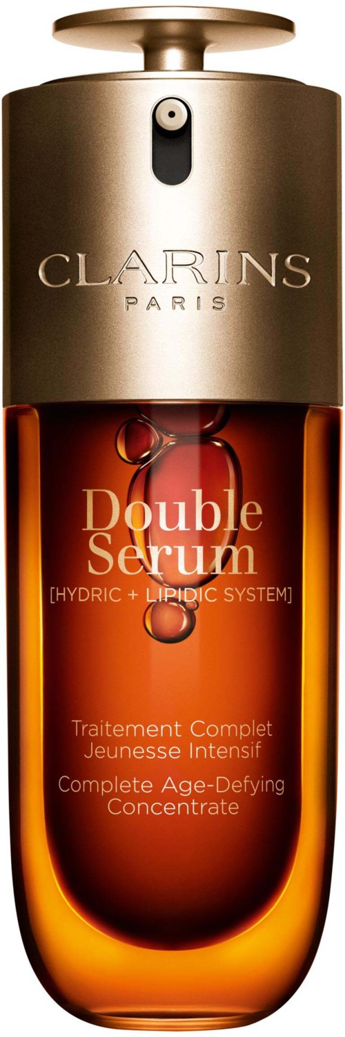 En brun och guldflaska märkt 'Double Serum' av Clarins med ett silverlöv, innehållande hudvårdsprodukt.