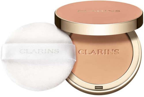 A round compact with beige powder inside and a pink lid, with a white powder puff next to it.