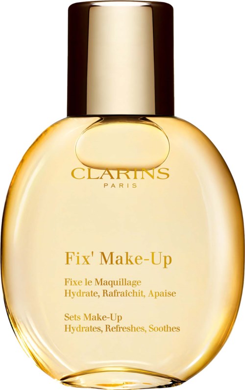 En klar, oval formad flaska med guldlock, märkt 'CLARINS PARIS,' innehåller Fix' Make-Up produkt för hydrering och uppfriskning.