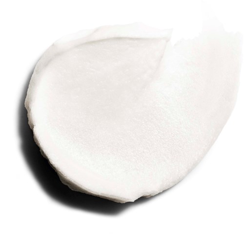 En vit rund objekt, möjligen en kokosnöt eller tvål, med en slät yta och en mörk skugga.