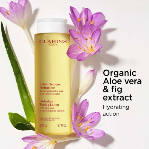 Clarins kosteuttava voidepulloa, jossa on pinkkivaatteisia kukkia ja tuotteen hyödyt merkitty.