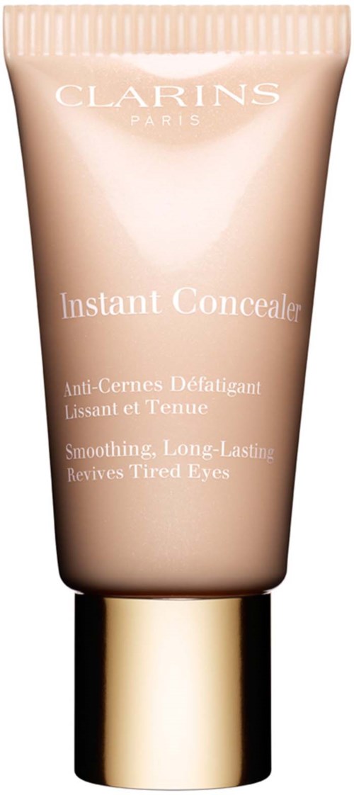Clarins Instant Concealer tube with beige color, gold cap, and text describing its purpose for tired eyes.
