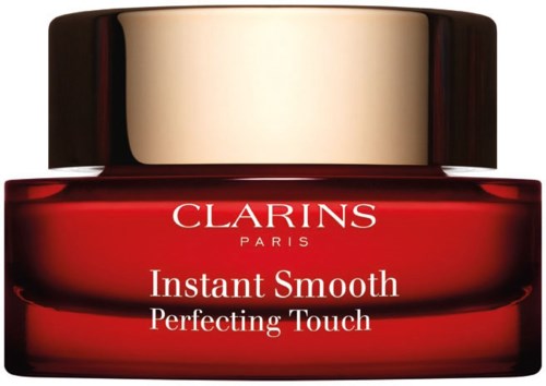 Punainen purkki kultakauluksella, jossa lukee "Clarins Paris" ja "Instant Smooth Perfecting Touch."
