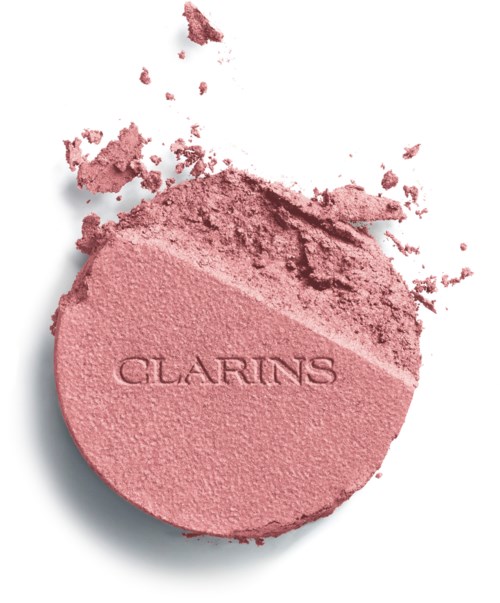 Pyöreä vaaleanpunainen irtopuuteri, jossa lukee "CLARINS", osa pölystä on levinnyt ympärille.