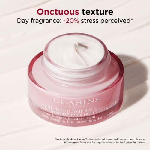 En rosa burk med Clarins ansiktskräm med vit kräm inuti. Texten handlar om textur och stresslindring.