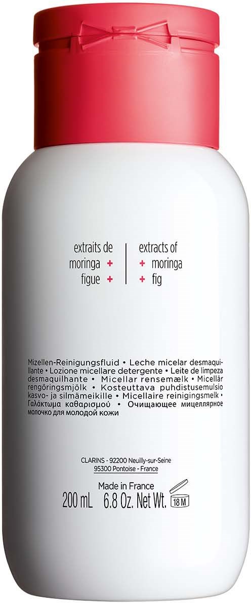 En vit flaska med röd lock, visar ingredienser som moringa, fikon och fikonextrakt, samt text på främmande språk.
