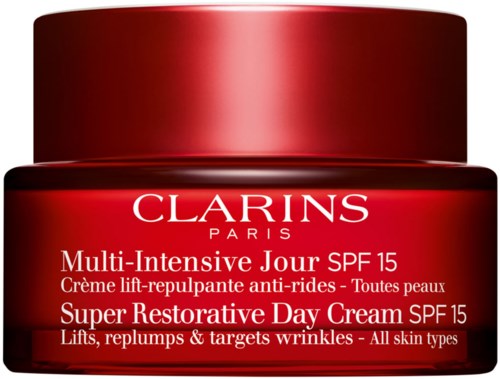 Röd burk av Clarins Super Restorative Day Cream SPF15 med vit text om hudfördelar.