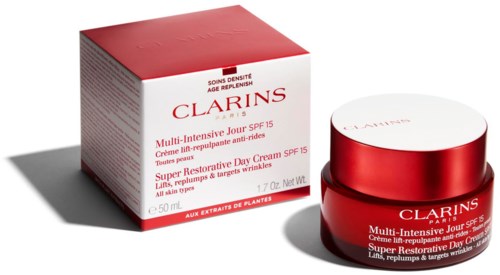 Röd och vit hudvårdsprodukt med ask och burk, märkt som Clarins multi-acting kräm, SPF 15, för alla hudtyper.
