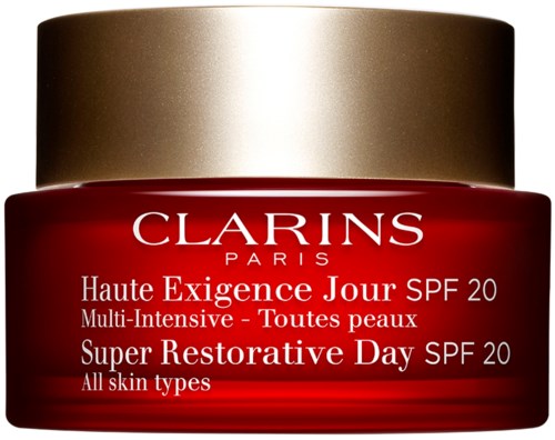Röd och guldkräm för hudvård, märkt med SPF 20, för alla hudtyper, av Clarins Paris.