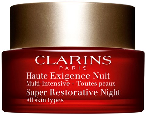 Röd burk med guldlucka, märkt Clarins Paris, nattkräm för alla hudtyper, superåterhämtande.