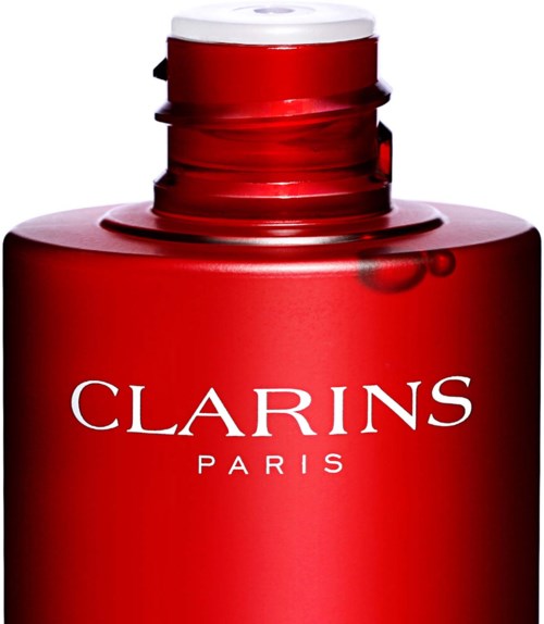 En röd flaska med vit öppning, märkt 'Clarins Paris' i vita bokstäver.