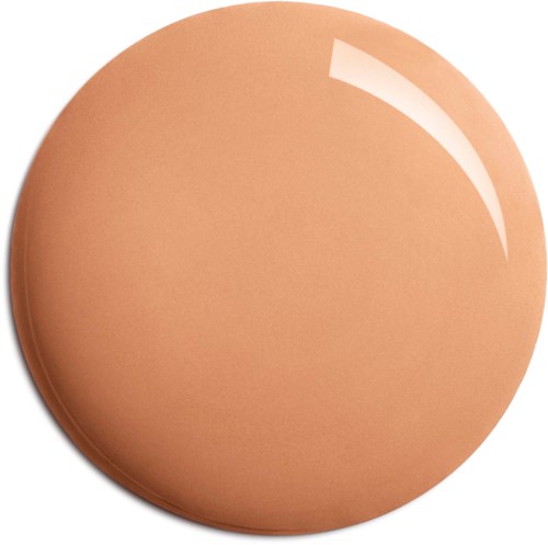En rund, beige sminksvamp med slät yta och ljusreflex.