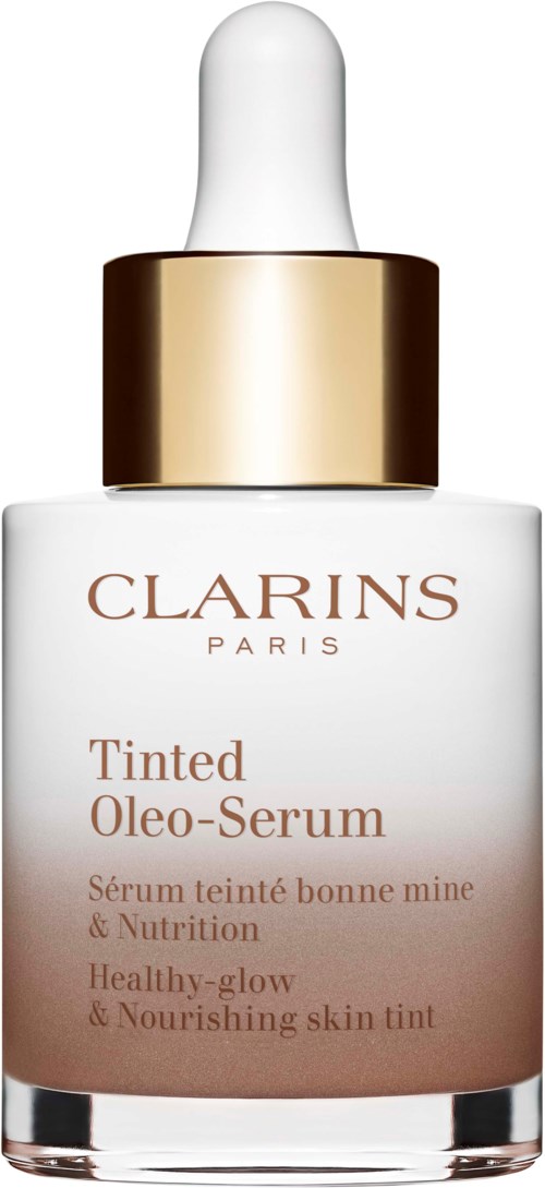 En vit flaska med droppkork, gyllene band och etikett för Clarins Tinted Oleo-Serum. Den främjar hälsosam, glödande och näringsrik hy.