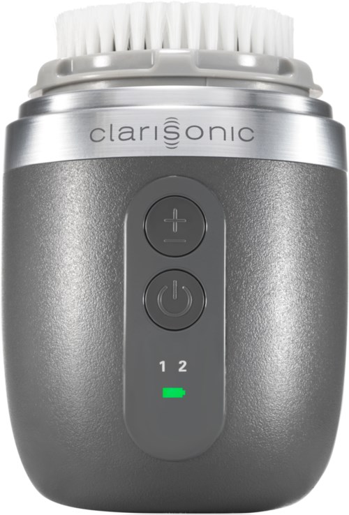En Clarisonic ansiktsrensingsenhet med kontrollknapper og en indikatorlampe. Enheten har et hvitt børstehode og en grå kropp.