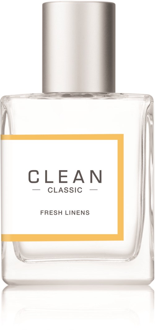 En klar parfymflaska märkt 'CLEAN CLASSIC FRESH LINENS' med en silverkork.