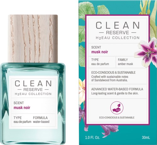 A perfume bottle and box with a white label, pink text, and floral designs in the background.