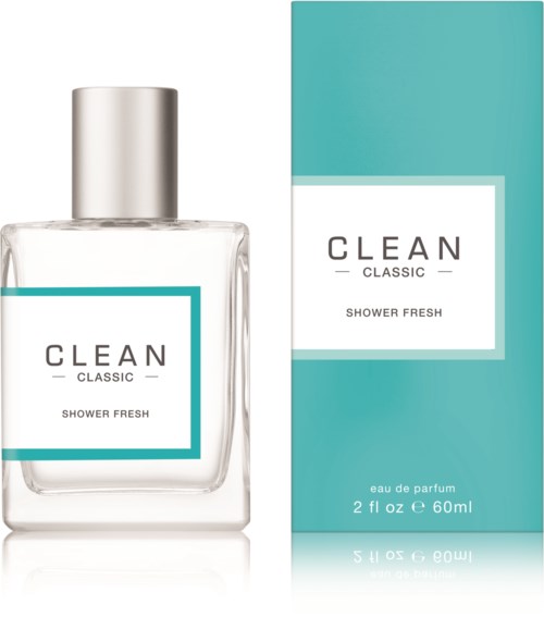 Eine klare Parfümflasche mit silberner Kappe neben einer türkisfarbenen Schachtel mit der Aufschrift 'CLEAN Classic Shower Fresh'.