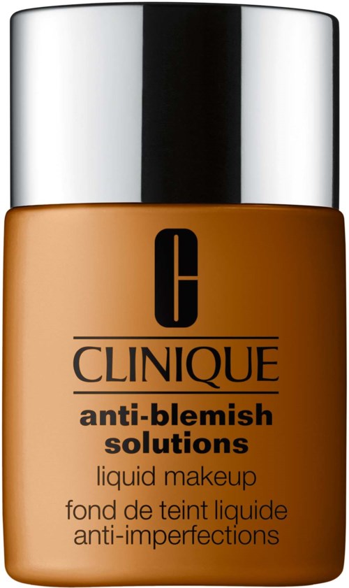 En flaska Clinique anti-blemish flytande makeup med svart text på en brun bakgrund och ett glänsande silverlock.
